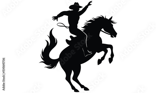 Silhouette of a cowboy riding a bucking bronco