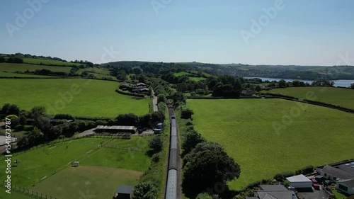 Churston, South Devon, England: DRONE VIEWS: A steam train on route from Paignton to Kingswear on the Torbay steam railway. Devon is a popular UK holiday destination with many visitor attractions.