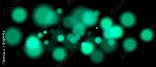 Green blurred bokeh particles with varying size and opacity on black background. Abstract design element for festive or sci-fi scenes.
