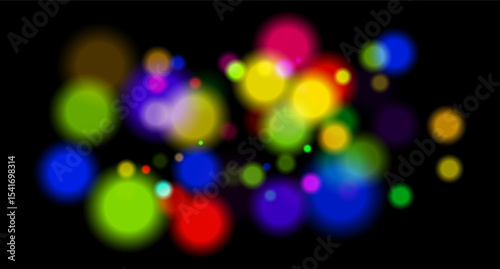 Multicolored glowing circles on dark background. Blurred soft shapes of various sizes create abstract festive atmosphere.