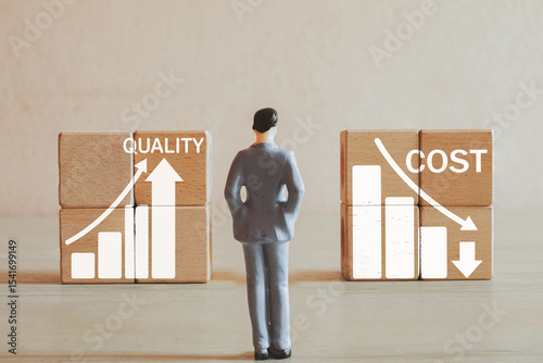 Concept of lean manufacturing,Six Sigma,business strategy, operational excellence, value optimization.,Businessman looking wooden cube with improving quality and reducing cost icon idea for business.