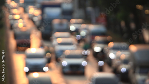 City Commute Rush Hour: Capture a blurred, abstract view of cars during a rush hour commute, depicting the motion of traffic flow, and transportation in an urban environment. 