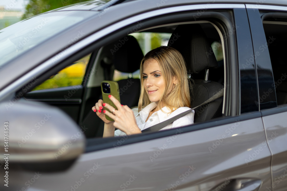 Businesswoman using smartphone while sitting in car Businesswoman using smartphone while sitting in car