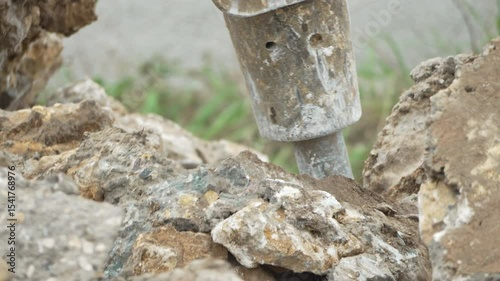Drill Breaking Concrete into hard surface on construction site