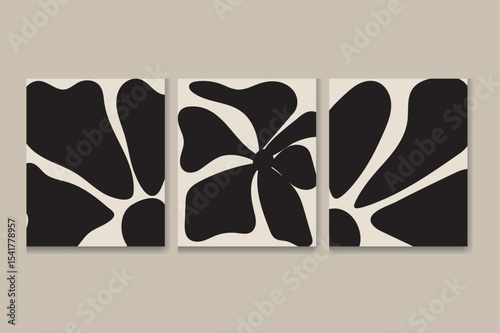 A triptych of canvas prints features a stylized floral design. The artwork is in black and white, with bold, simplified floral shapes on a creamy off-white background. Each panel shows variations of t