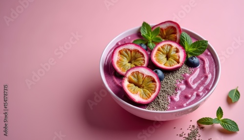 Colorful Smoothie Bowl with Fresh Fruit and Mint on Pink Background
