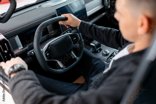 Photos Young caucasian driver male test driving new car at dealership, view of first po