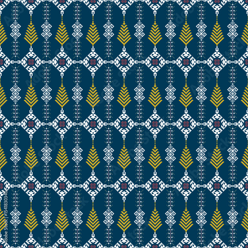 A detailed geometric textile pattern with blue, yellow, white, and purple colors, featuring symmetrical motifs resembling wheat stalks and diamond shapes.