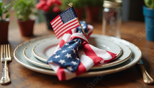 Festive table setting with white plate, napkin, and small USA flag.