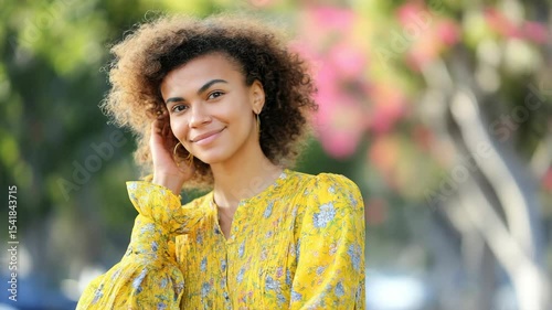 Woman in a yellow floral print dress outdoors