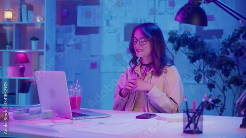 Digital Confidence, Remote Work, Neon Mood. Woman Sits in Stylish Home Office and Talks in a Business Video Call. Clear Focus and Authority in a Bold Creative Space