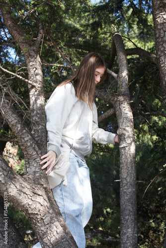 young pretty girl dreaming on tree, lifestyle people concept