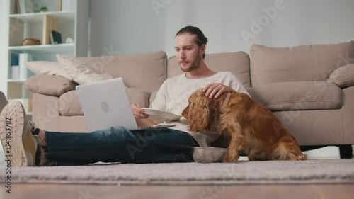 Healthy Routine, Pet Human Nutrition, Digital Balance. Man Works and Eats at Desk While His Dog Enjoys Its Own Food Nearby. Calm, Synchronized Wellness and Everyday Focus