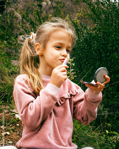 little cute girl with mirror outside playing having fun, lifestyle people concept