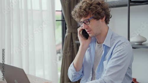 Creative designer or business entrepreneur talking on the phone to dealing with customer and checking customer order at home. Work remotely concept