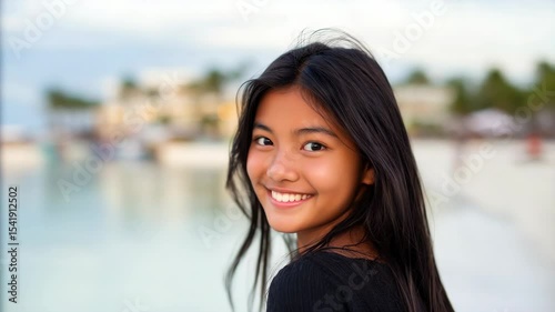 Smiling girl outdoors by water