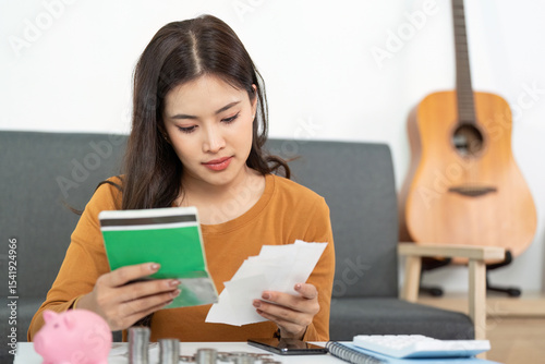 Financial Organization and Planning. Woman reviewing financial documents and savings. photo