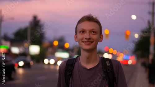 Person walking down a city street at dusk