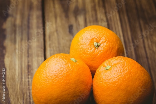 Close-up of oranges on wooden table