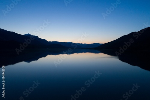 Scenic view of lake against clear blue sky