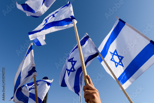 Blue and white flags of the State of Israel held aloft during the celebration parade of Jerusalem Reunification Day in Israel.