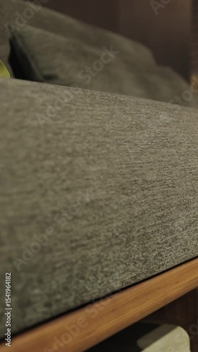 Vertical video. Close-up of the sofa fabric. A modern sofa set is beautifully placed in a stylish living room setting that captivates and captivates