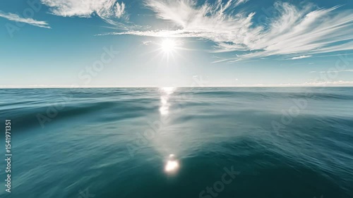 Calm Ocean Water with Sunlight Reflection and Distant Island View