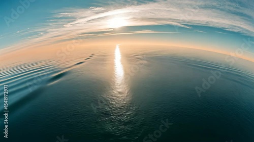 Calm Ocean Water with Sunlight Reflection and Distant Island View