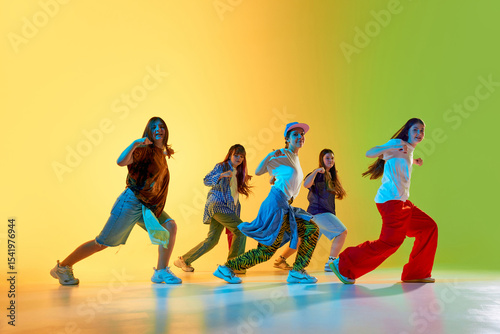 Youthful dancers showcase vibrant moves in a colorful urban setting, expressing creativity and energy. Concept of modern dance culture in city environments.