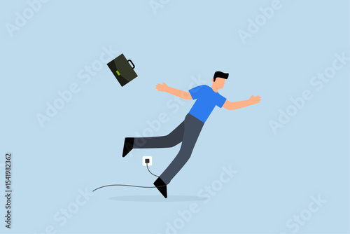 clumsy businessman tripping over power cord electrical plug that fell to the floor.
