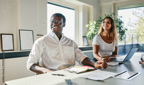 Two diverse Colleagues Collaborating in a Bright Modern Office Environment