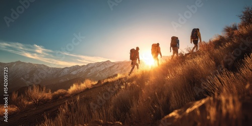 The hikers ascend a mountain trail at sunset, embracing nature's beauty.