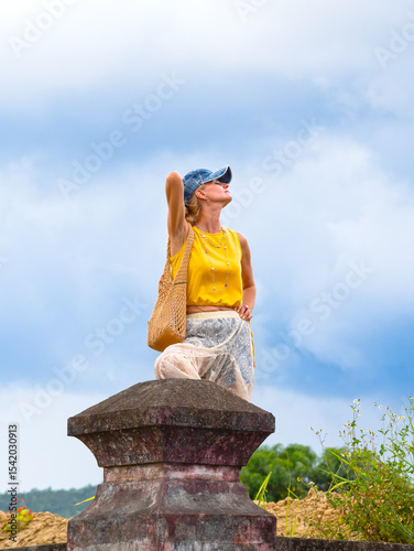 A woman posing at ancient ruins in Nha Trang, Vietnam - a moment of silence amidst the historical heritage and nature of Southeast Asia. Tourism concept