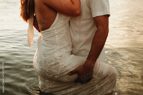 close up of couple embracing in a lake