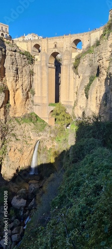 Beautiful old stone bridge at sunset. Useful street in the old town. Scenic view from the path in the mountains. European landmark for sightseeing. Must-see grand canyon national park.