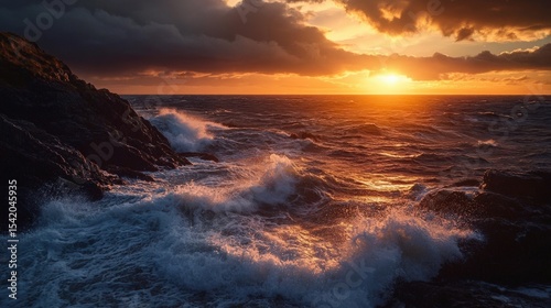 The Ocean Waves Crash Against The Rocky Shoreline At Sunset