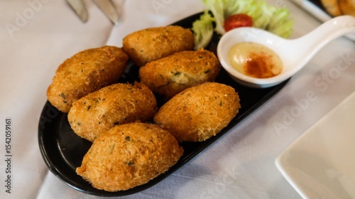 Canvastavla close up of six pieces of Bacalhau fritters ( fried salted cod fritters) a tradi