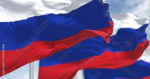 Several flags of the Russian Federation waving in the wind.