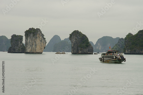 February 25, 2024, Lan Ha Bay: Tourist boat and limestone cliffs. Cat Ba Archipelago. Vietnam.
