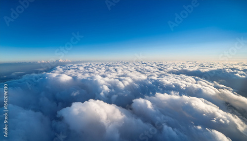 bird s eye view over a blanket of clouds under a clear blue sky