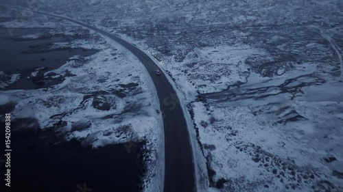 A Scenic and Inviting Winter Road Amidst a Foggy Mountain Landscape Perfect for Exploration