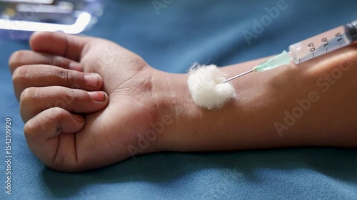 hand receiving injection with cotton support at indoor
