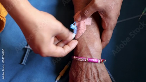 cannula inserted in patient’s hand safety measures at daytime indoors