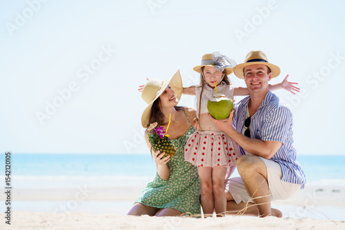 Happy caucasian family with father, mother, and daughter portrait on the beach.