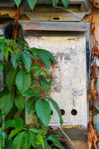 old post box on the wall of a building, old weathered paint