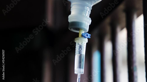 iv drip droplets flowing in tube near hospital window