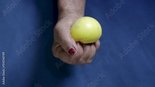 disabled person pressing smiley ball in hand for strengthen the muscles at indoor