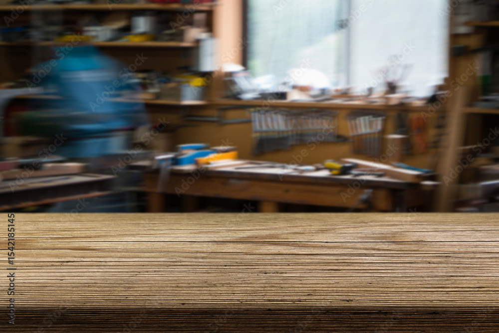 Crafting tools and wooden surfaces in a busy workshop during the day with a blurred background of activity