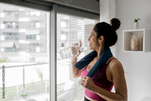 Woman staying hydrated during home workout