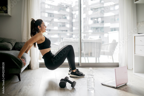 Woman doing home workout with dumbbells